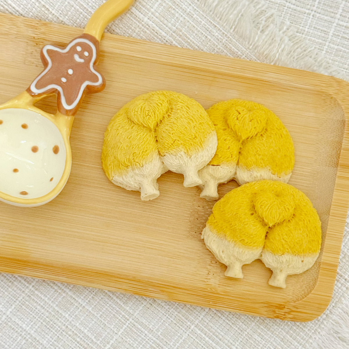 Golden corgi butt-shaped chicken cookies on a white plate – handmade pumpkin dog treats