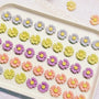 Handmade daisy-shaped chicken cookies with yellow, purple, pink and orange petals on a white plate