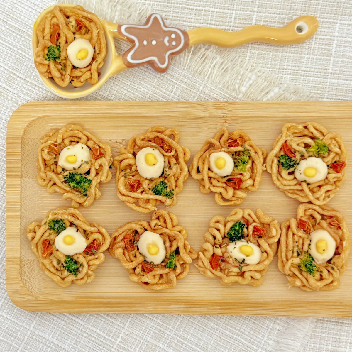 Side angle of the mini ramen bowl dog treat with broccoli and carrot pieces
