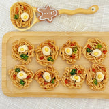 Side angle of the mini ramen bowl dog treat with broccoli and carrot pieces