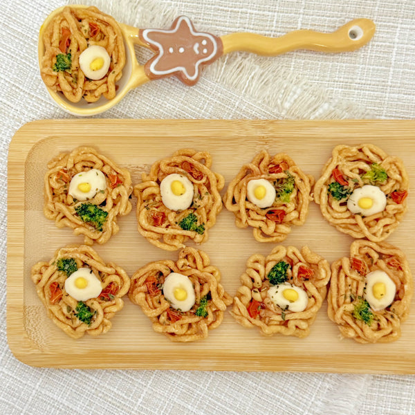 Side angle of the mini ramen bowl dog treat with broccoli and carrot pieces