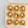 Chicken ramen bites for dogs styled as a tiny ramen bowl with broccoli, carrot and a sunny-side-up egg topping – handmade dog treats