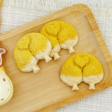 Close-up of a corgi butt cookie showing the golden pumpkin-powder crust and hand-shaped details