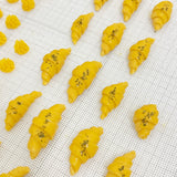 Mini croissant dog treats arranged on white linen – handmade French bakery style